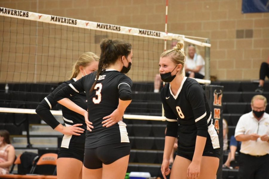 Senior captains Katelyn Gardner and Maggie Olson exchanging conversation on the court